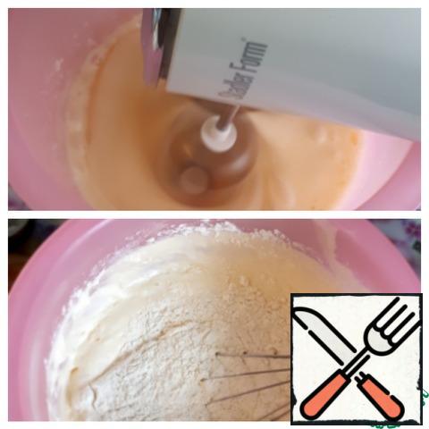 This amount of ingredients makes two rolls. First, prepare a sponge cake-light and dark cakes. To do this, 3 eggs and 90 gr. beat the sugar until the mass increases, add 90 grams of flour and gently knead the dough.