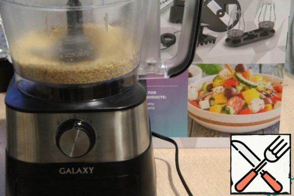 Grind the nuts in a blender with 2 tbsp of sugar (of the total amount) on a pulse mode. This is very convenient to do using the blender attachment of the combine.