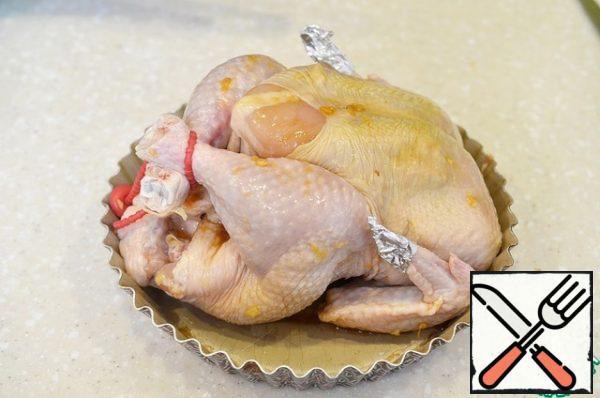 Put the carcass in a heat-resistant form, tie the legs, wrap the tips of the wings with foil, so as not to burn. Bake the chicken in a preheated 180 degree oven, covered with foil for the first 40 minutes of baking. Then remove the foil and cook until browned for about another 20 minutes.