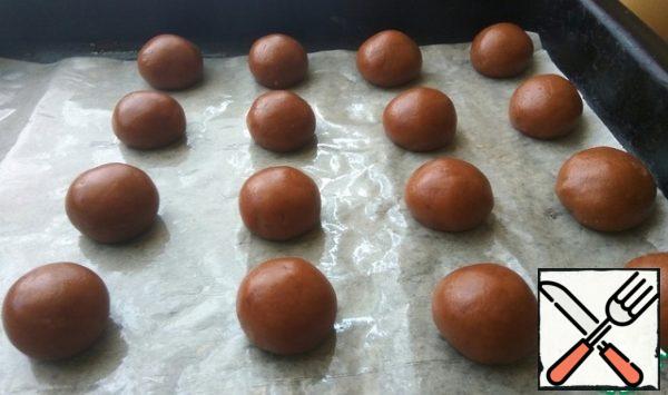 Roll 20 balls out of the dough.
Place the dough balls on a parchment-lined baking sheet.
