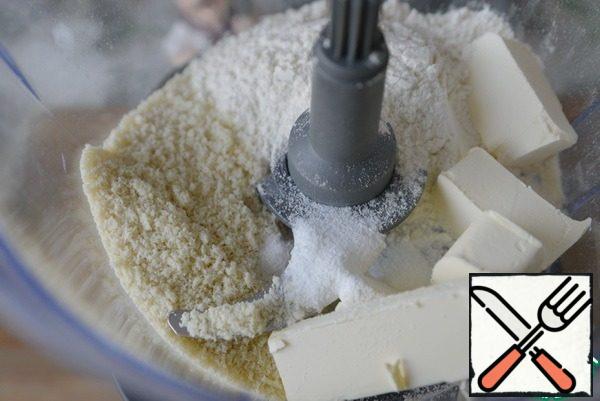 We get the butter in advance, about 1 hour, it should be cold, but not ice cream. In the bowl of a food processor put the butter, flour, almond meal, icing sugar, salt. Mix (grind) with knives.
