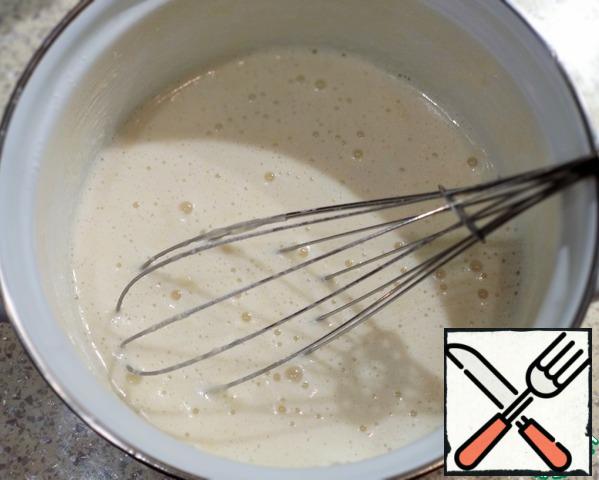 Add the milk and sift the flour. Stir well. Put on a small fire. Continuously stir the mass to avoid the formation of flour lumps. As soon as the custard thickens and begins to boil, remove from the stove.