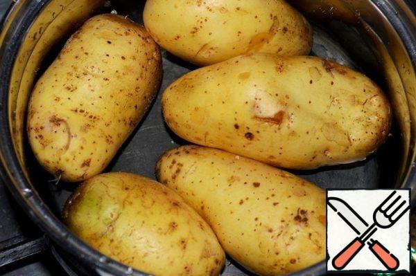 Wash the potatoes and boil in the peel until tender. Also boil the eggs until tender and cool.
