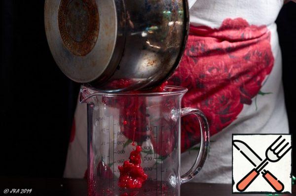 Put the hot berries in a ladle and whisk them into a puree using a blender.
