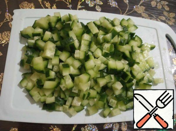 Cut into small cubes fresh cucumbers.