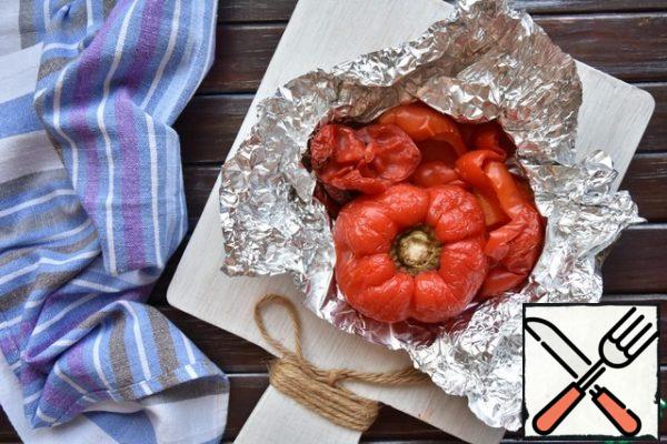 Wrap the bell peppers and hot peppers in foil and bake in the oven at 180 degrees for 20 minutes. Then cool, remove the seeds and thin film from the skin.