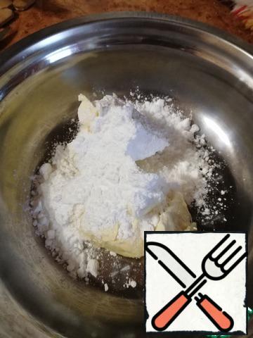 Everything is done very simply and quickly. For the dough, quickly mix the softened butter with powdered sugar with a silicone spatula.