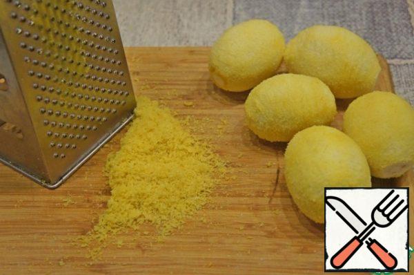 Wash the lemons and grate the yellow part of the zest.