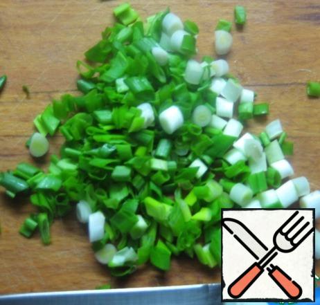 Finnely chop green onion.