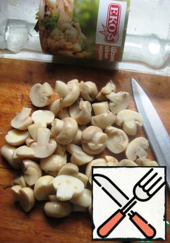 Marinated mushrooms cut in half.