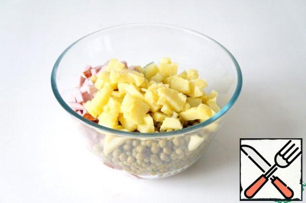 Add the cooled and sliced potatoes.
