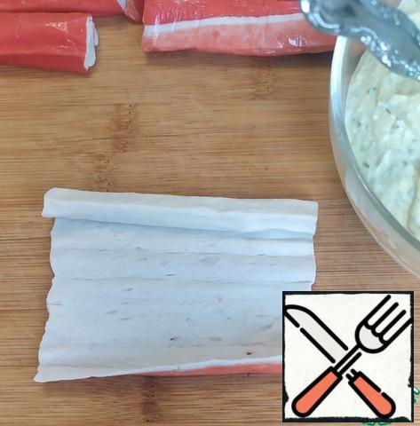Then carefully expand the crab sticks.
