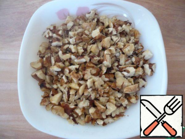 Chop walnuts with a knife.