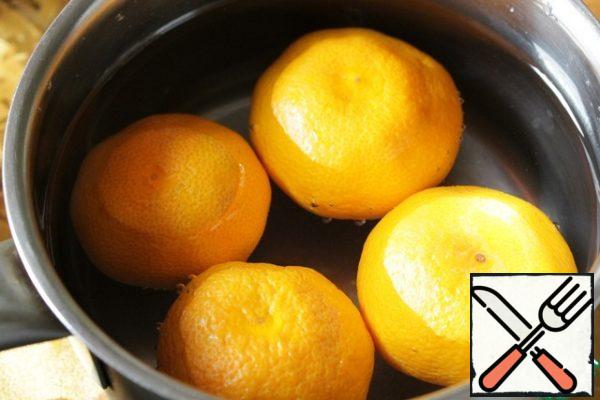 Wash the tangerines thoroughly, put them in a saucepan, cover with water and bring to a boil, then cook over low heat for 20 minutes.