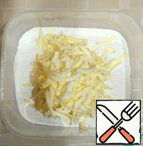 Sift the flour into a bowl and grate the cold butter on a coarse grater.