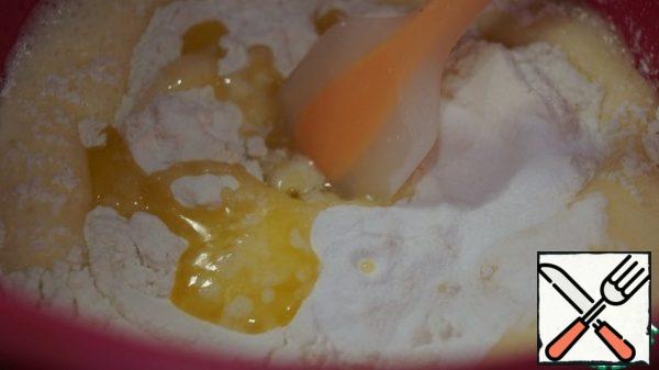 Add flour, baking powder and melted butter.
