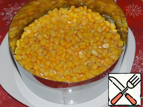 Put 0.5 cans of corn on top of the cheese.