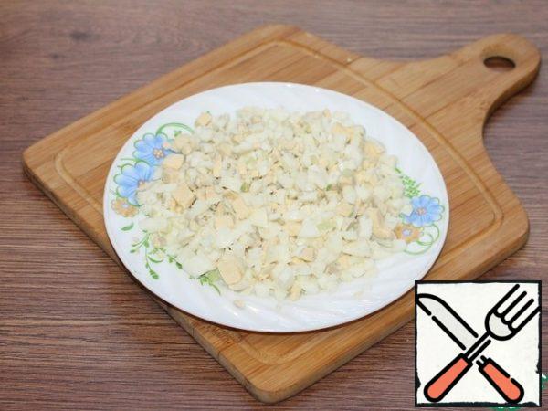 Boiled and peeled eggs cut into small cubes.
