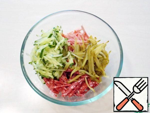 Fresh and pickled cucumbers cut into strips and add to the meat slicing.