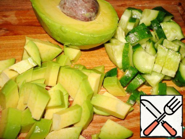 Cut the cucumber into cubes. Peel the avocado and cut into cubes too.
