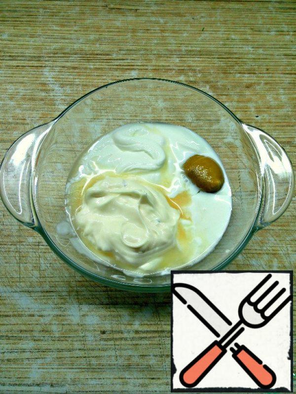 In a separate bowl, mix mayonnaise, sour cream, apple cider vinegar and mustard. Add salt and pepper to taste and beat thoroughly until the salt dissolves.