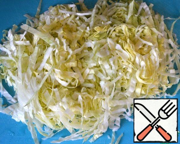 Cut the salad into thin strips. Transfer to a bowl. Boil the eggs in advance.
