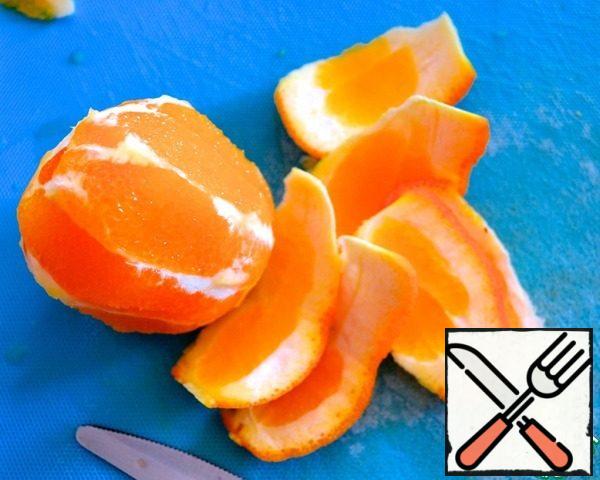 Peel the orange by milling (cutting it to fit the shape of the fruit).