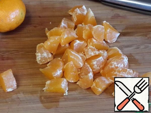 Disassemble the tangerine into slices. Cut each slice into 2-3 parts.