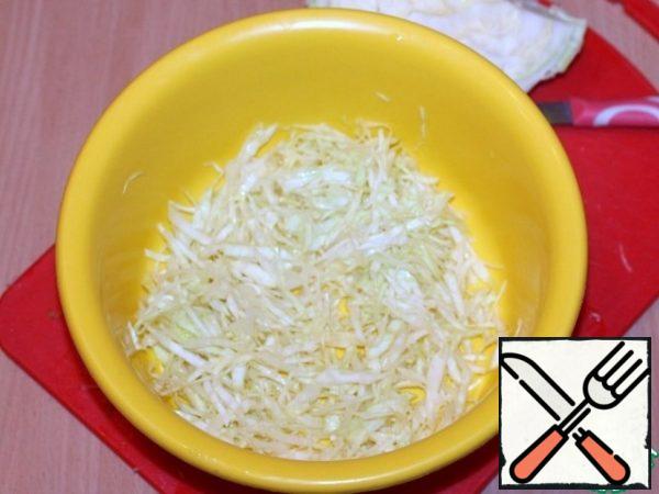 Chop the cabbage thinly and RUB with a small pinch of salt.