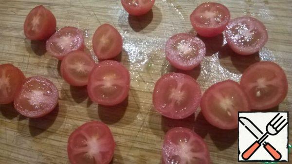 Cut tomatoes in half. Put on the leaves.