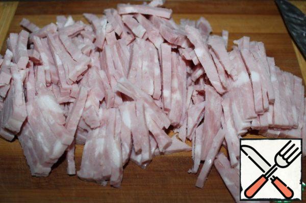 Boil the chicken fillet in salted water. While the fillet is cooling, cut the ham into small strips (the ham should be of good quality).