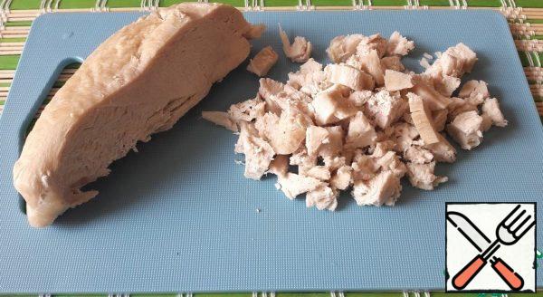 Boil the chicken breast. Cut into cubes.