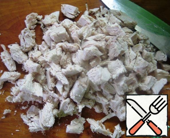Boil the chicken breast, let it cool, and cut into large pieces.