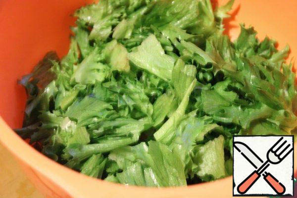 Wash the lettuce leaves, dry them, and pick them in a bowl with your hands.