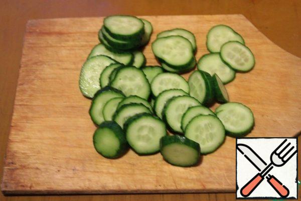 Wash the cucumber, dry it and cut it into rings.