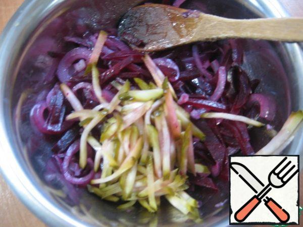 Cut the cucumber into strips and add it to the beets and onions.