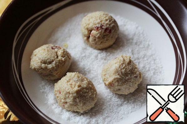 As soon as it becomes denser, roll small balls out of it and roll them in coconut shavings.