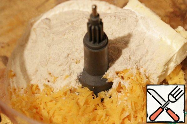 Put grated cheese, butter, flour, salt and pepper in the bowl of a food processor (knife attachment).