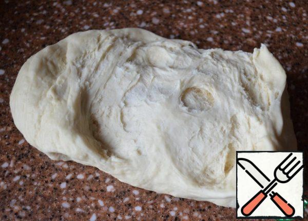 After an hour, knead the dough.