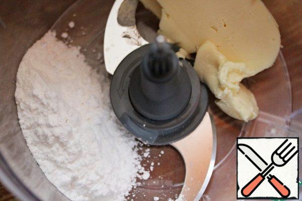 Put the room-temperature butter and powdered sugar in the bowl of a food processor.