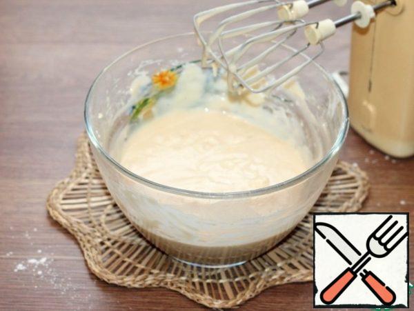 Mix the flour with the baking powder and sift into the oil liquid mixture. Beat the dough with a mixer until smooth.