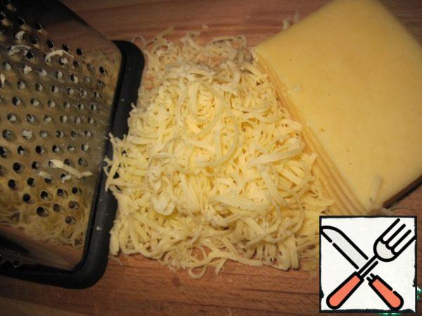 Grate the hard cheese on a fine grater.