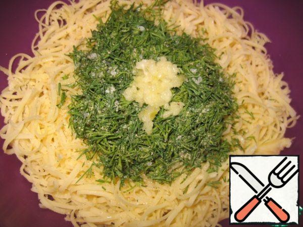 In a deep bowl, transfer the cheese, add the finely chopped dill, crushed small clove of garlic, a little ground pepper and salt to taste.