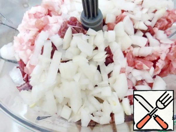Cut the onion into small cubes and add it to the bowl of a food processor.