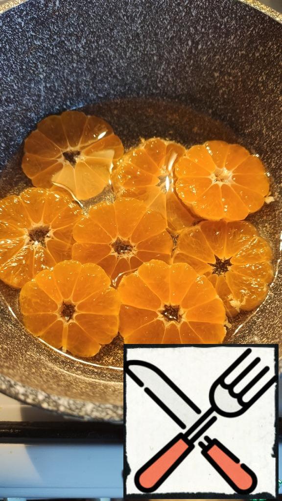 Cook the syrup from the water and sugar, put the circles of peeled tangerines, boil for 2 minutes, leave to cool in the syrup.