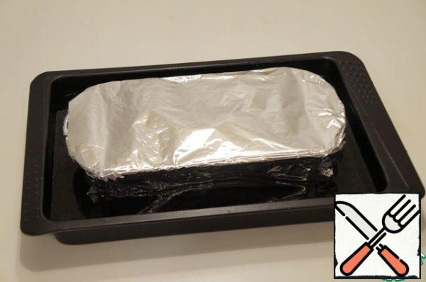 Cover the mold with foil. Place on a baking sheet. Pour water to reach 2/3 of the mold.