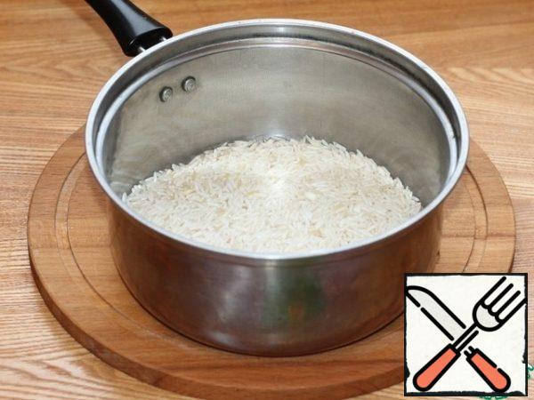 Wash the rice and boil it in salted water until it is half cooked. Then drain the water.