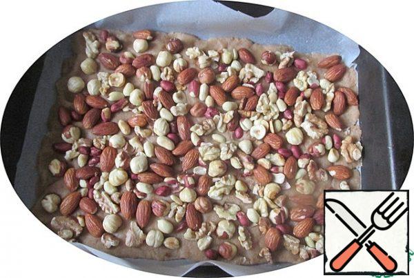 Put the nuts on the dough and press them into the dough a little.