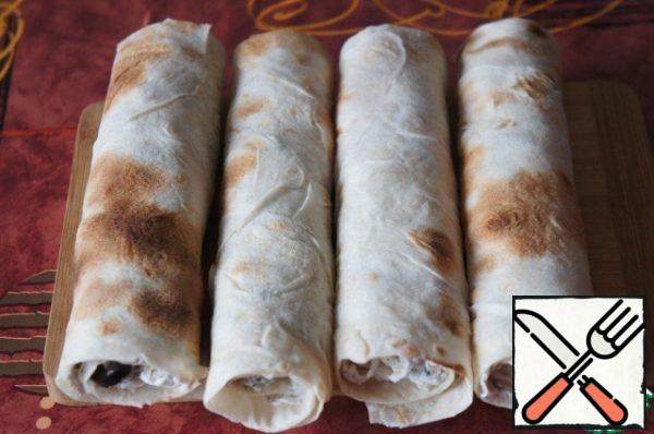 Roll the pita bread into rolls.