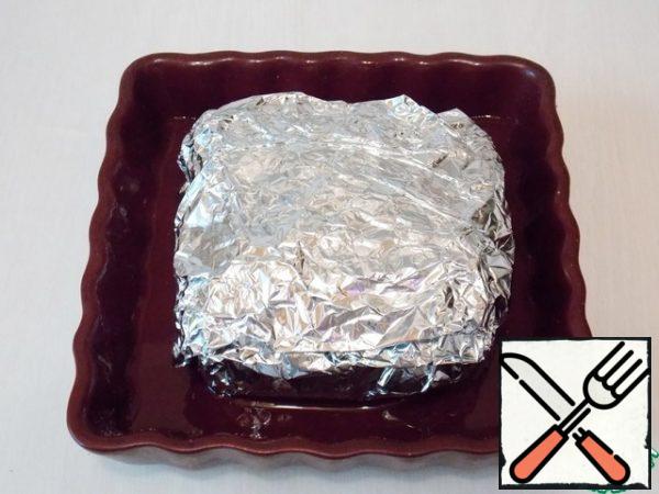 Tightly wrap the meat in foil and put it in a baking dish. Pour a little water into the mold so that the meat does not burn immediately.